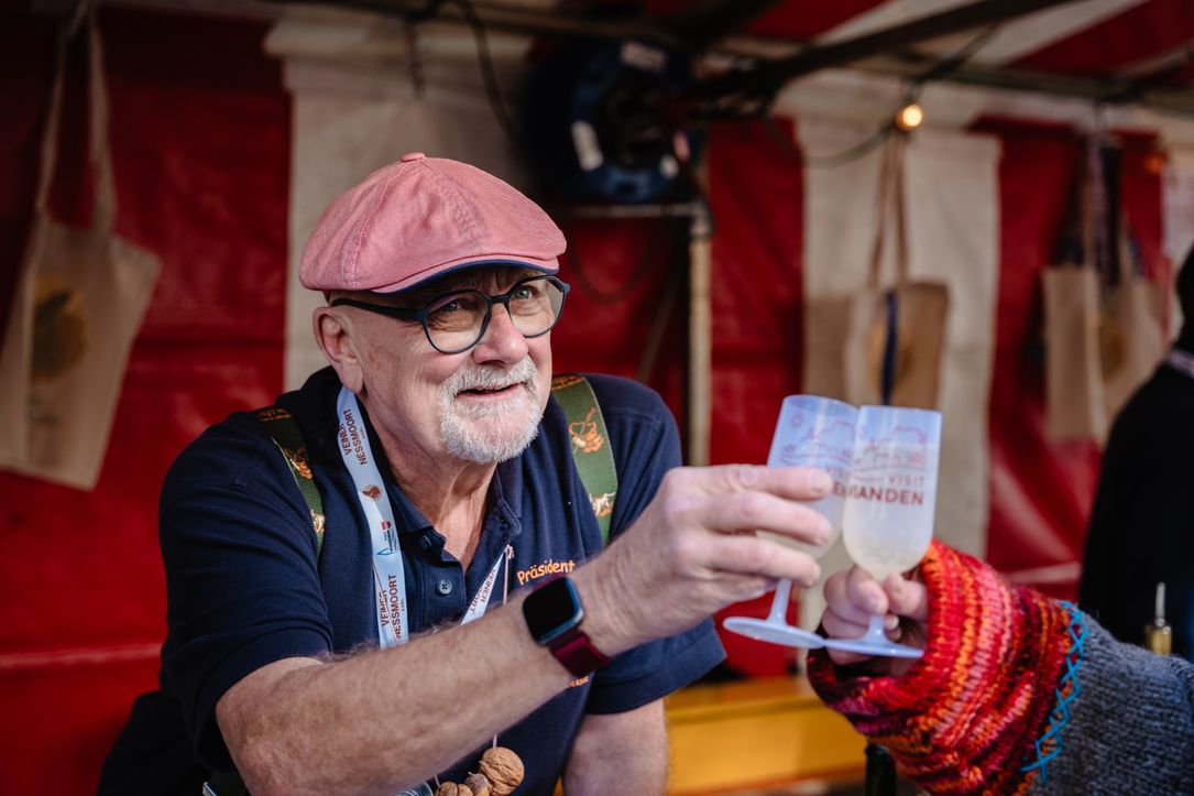 A vendor at the Nut Market in Vianden offers a sample of his products.